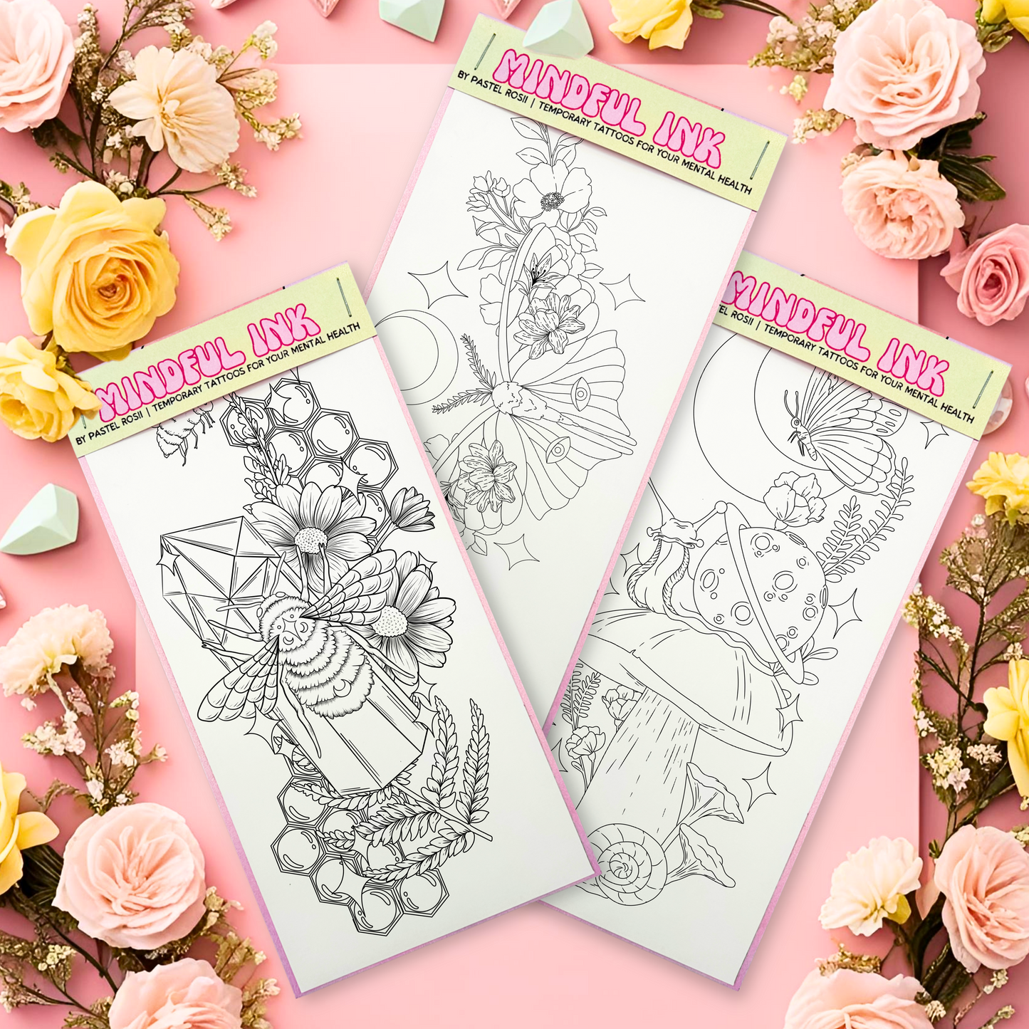Three sheets of temporary tattoo designs featuring floral, geometric, and nature themes, surrounded by pastel-colored flowers on a pink background.