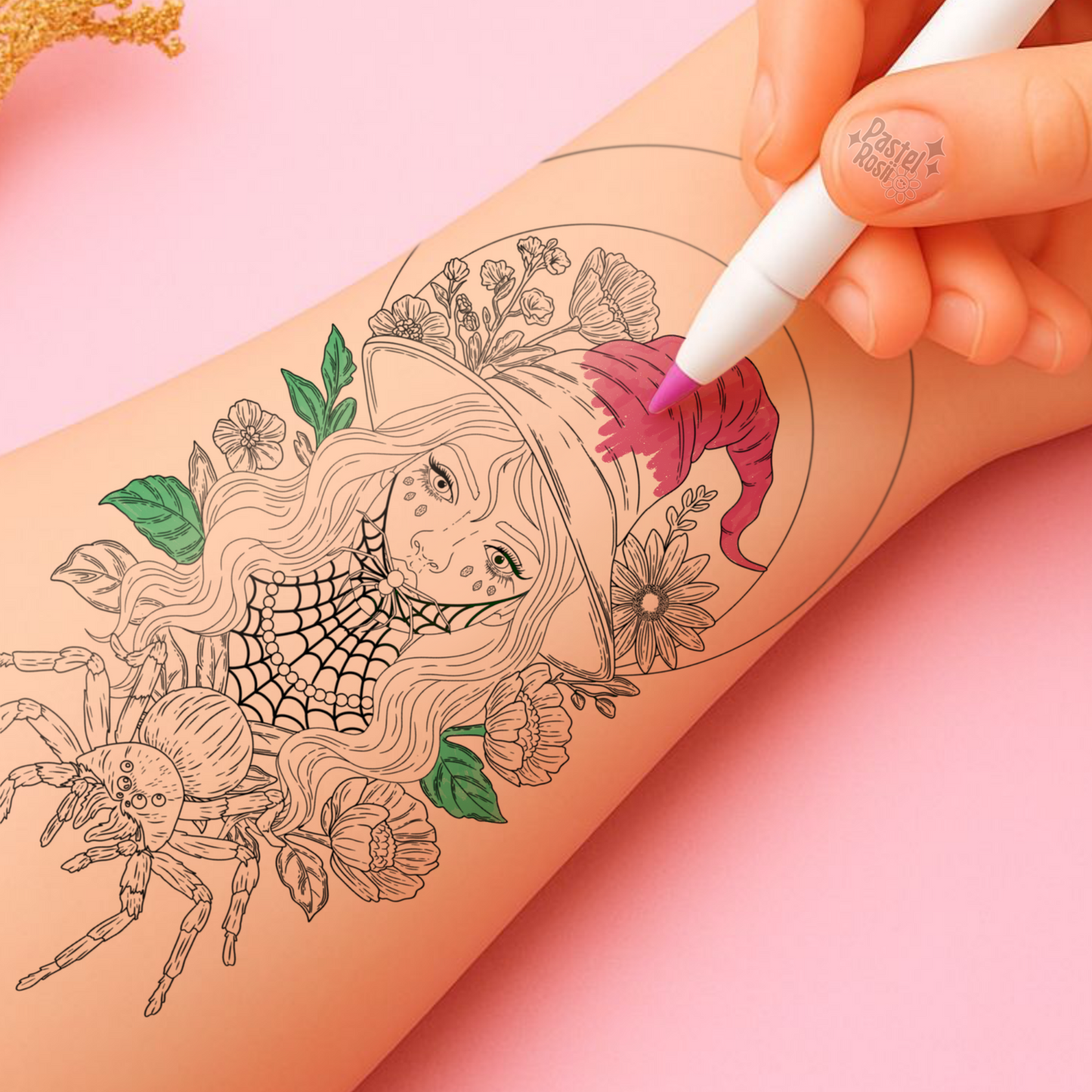 Tattoo design of a woman with flowers and a spider being colored on skin with a pink marker.