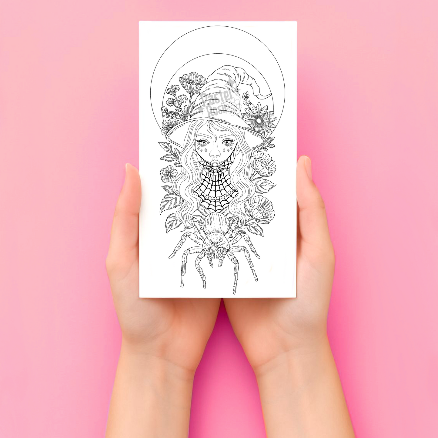 Hands holding a temporary tattoo with a detailed illustration of a woman with flowers and a spider on a pink background.
