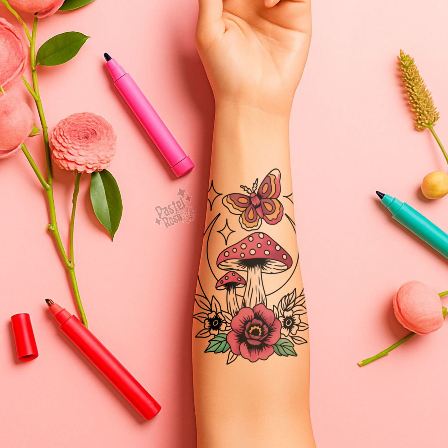 Tattoo of mushrooms, flowers, and a butterfly on a person's arm with pink markers and flowers on a pink background.