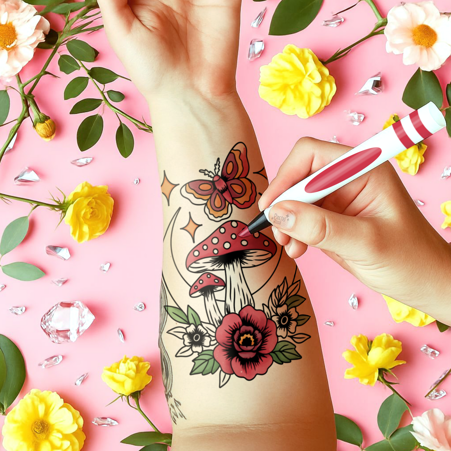 Temporary tattoo of mushrooms and flowers on a pink background with flowers and leaves.