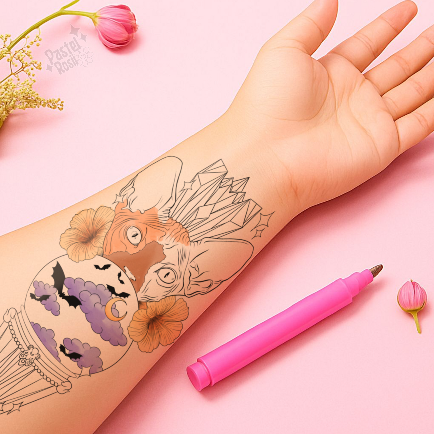 Hand with temporary tattoo of a cat and crystal design, pink pen on pink background