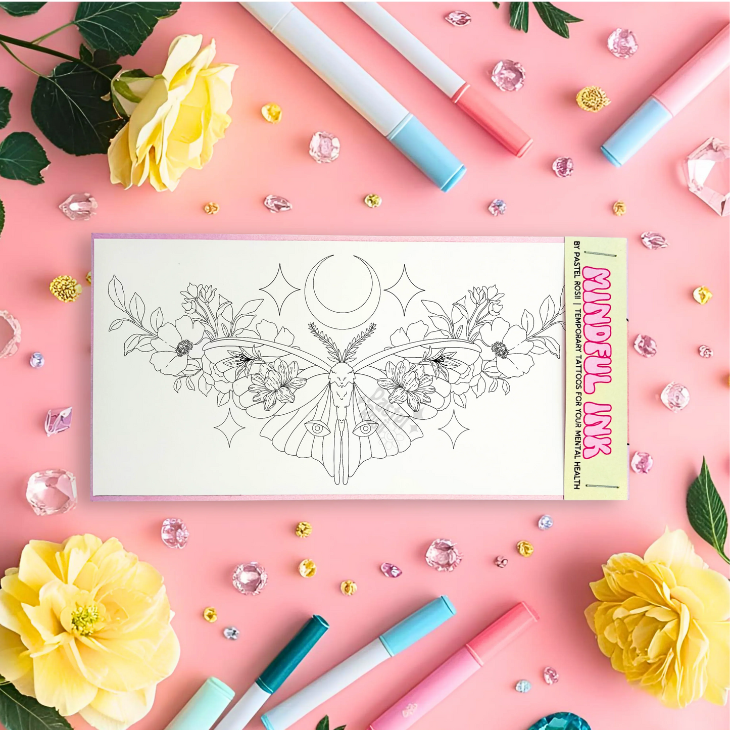 Floral temporary tattoo with markers and flowers on a pink background