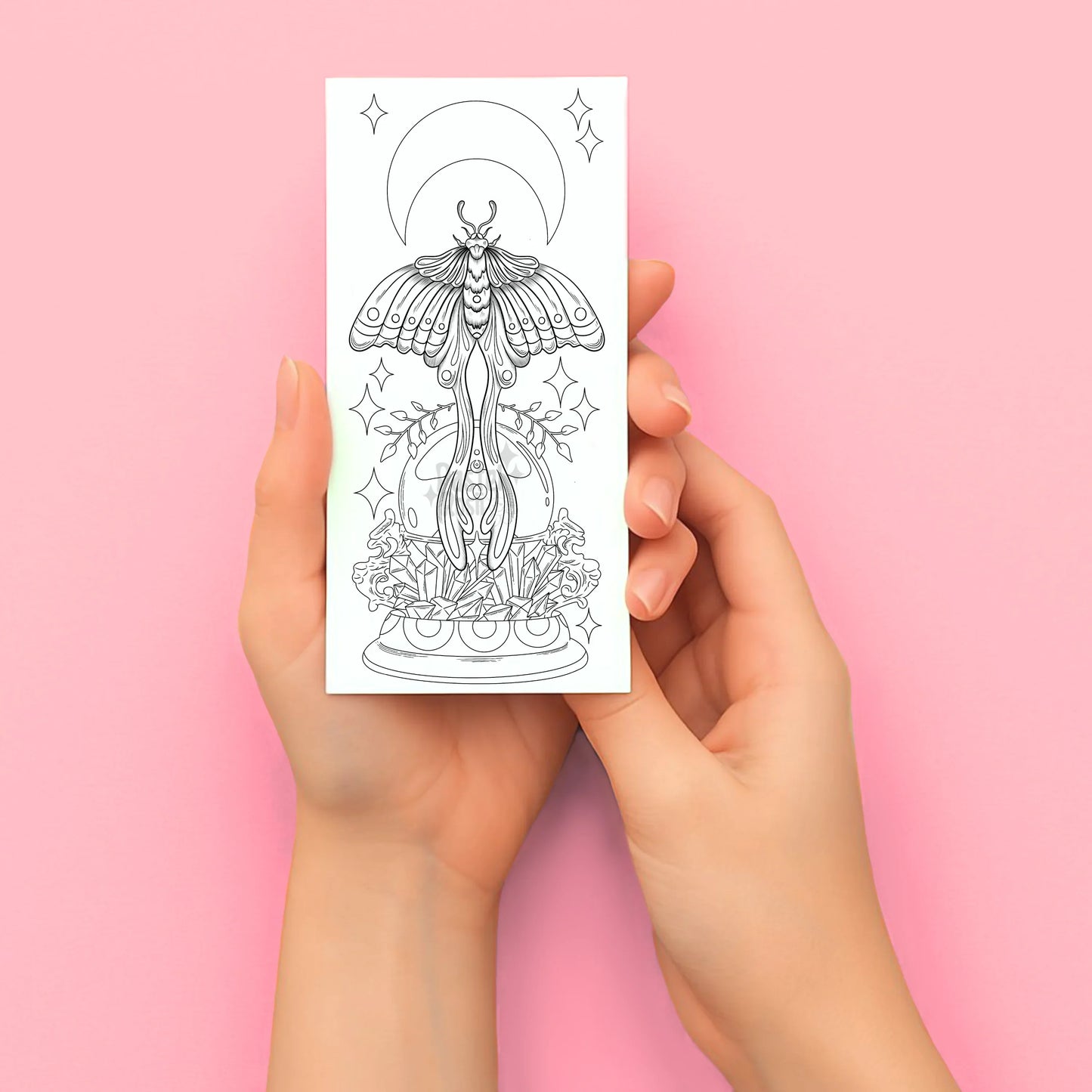 Hands holding a tattoo design sheet with a butterfly and floral illustration on a pink background