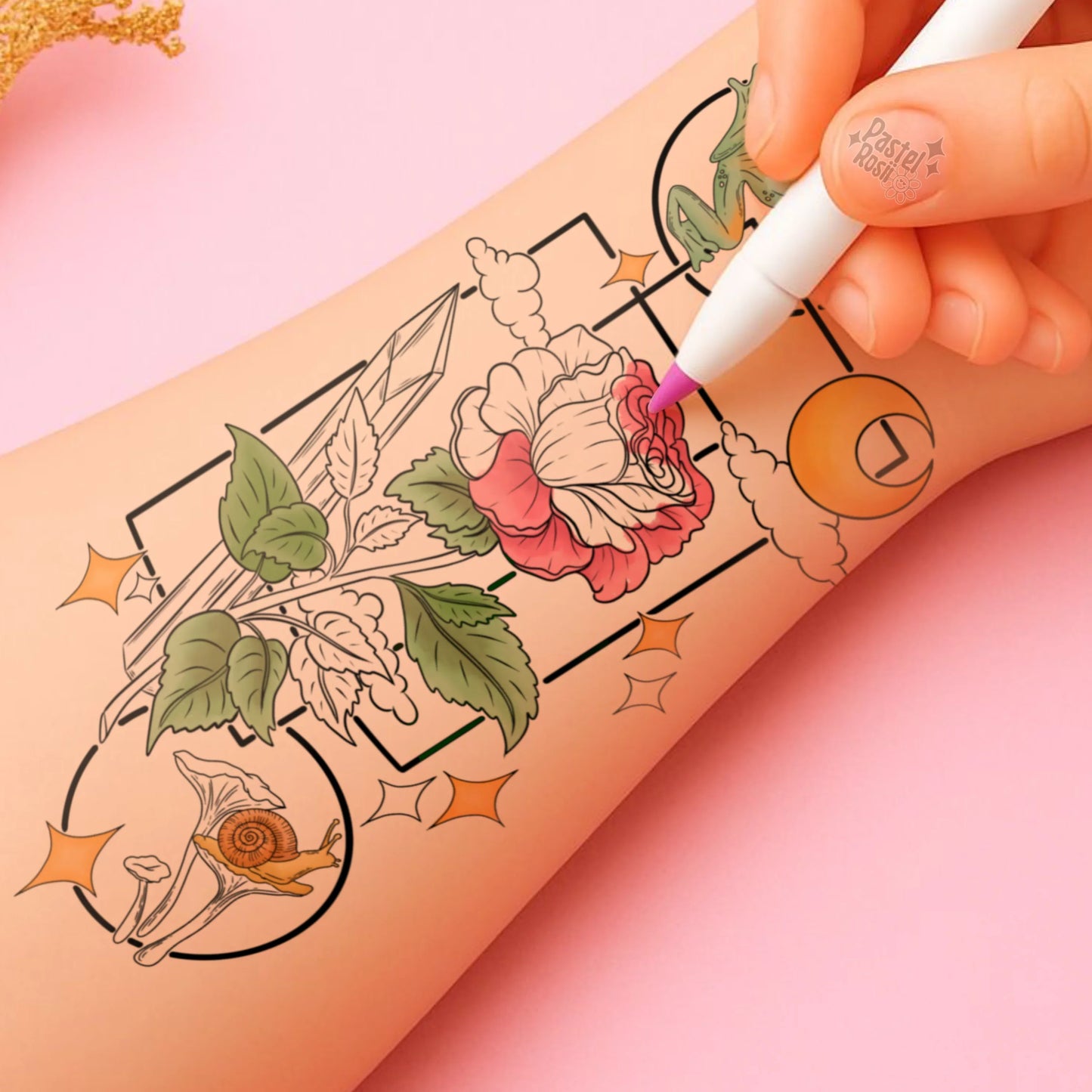 Hand with a tattoo pen coloring floral designs on skin against a pink background