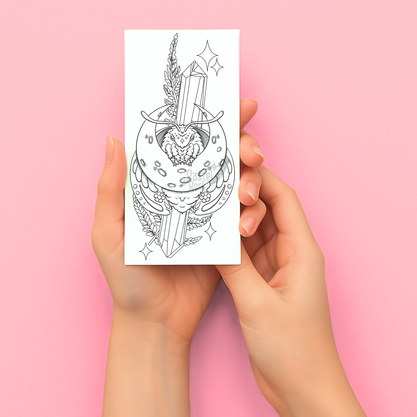Hands holding a temporary tattoo with a black and white tattoo design on a pink background