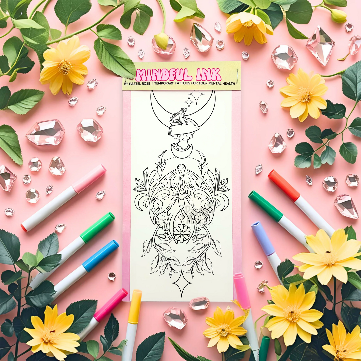 Mindful Ink temporary tattoo with markers and flowers on a pink background