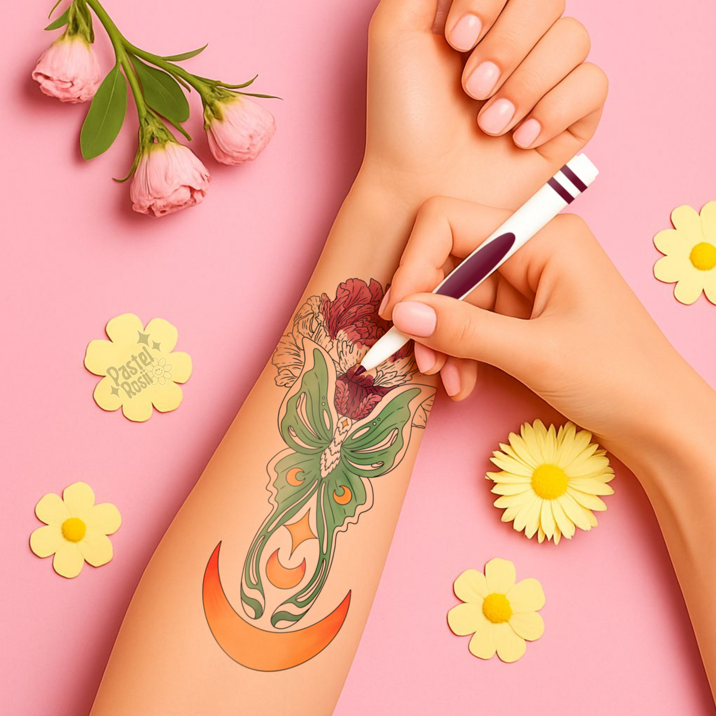 Hand with a floral tattoo design on a pink background with flowers.