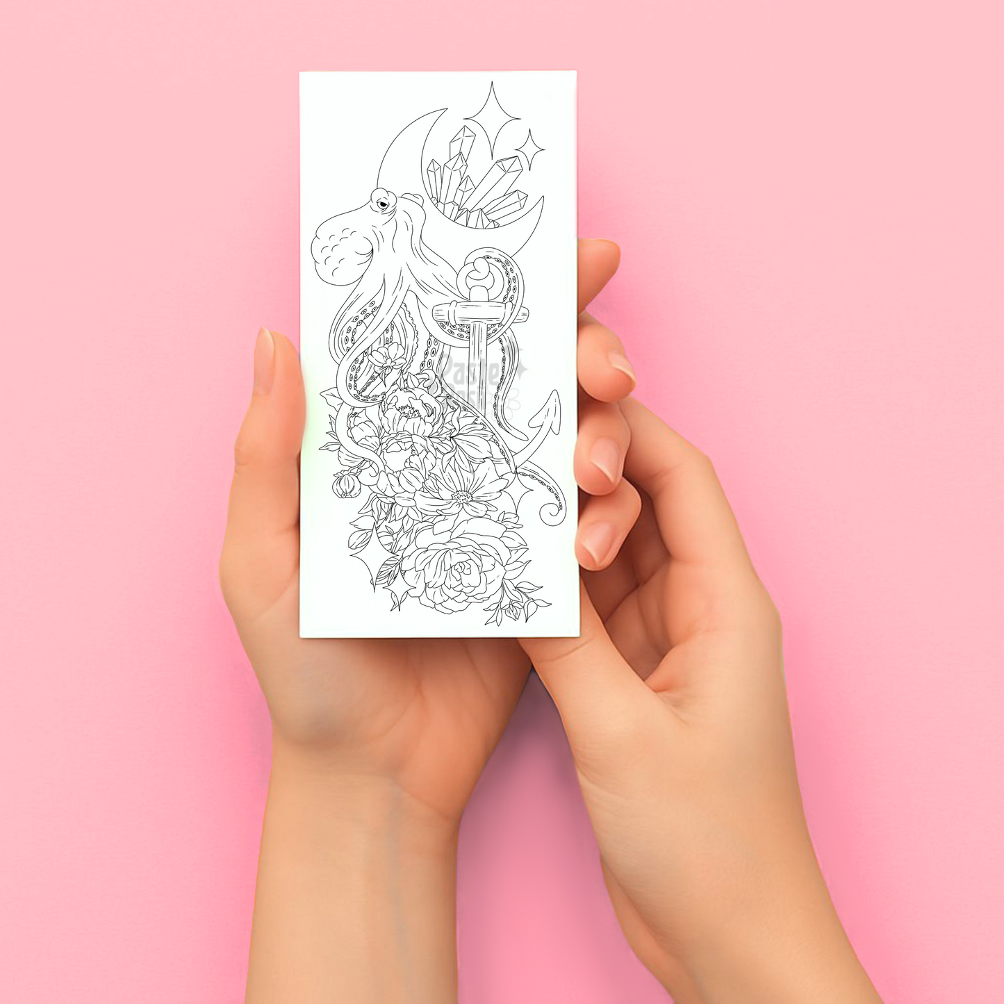 Hands holding a temporary tattoo with a detailed design on a pink background