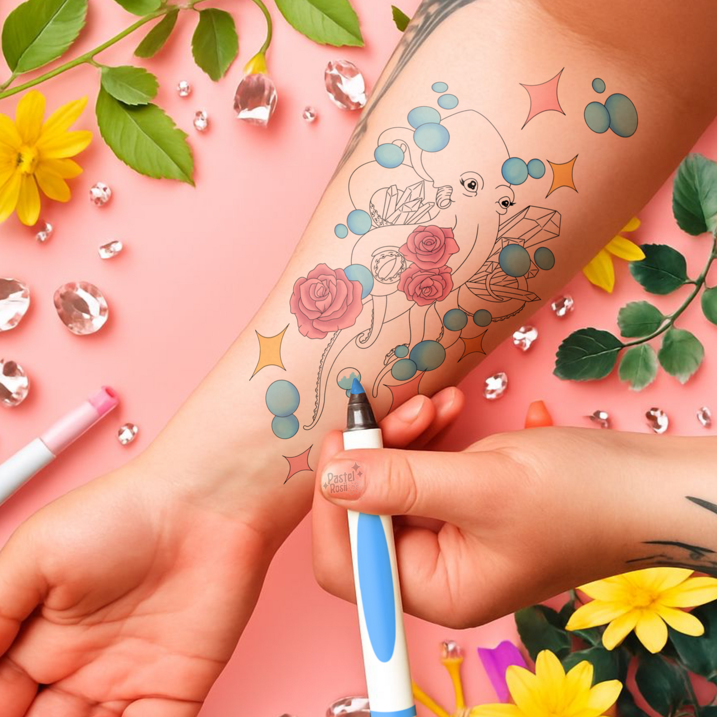 Person applying a temporary tattoo of a octopus with flowers on a pink background with decorative elements.