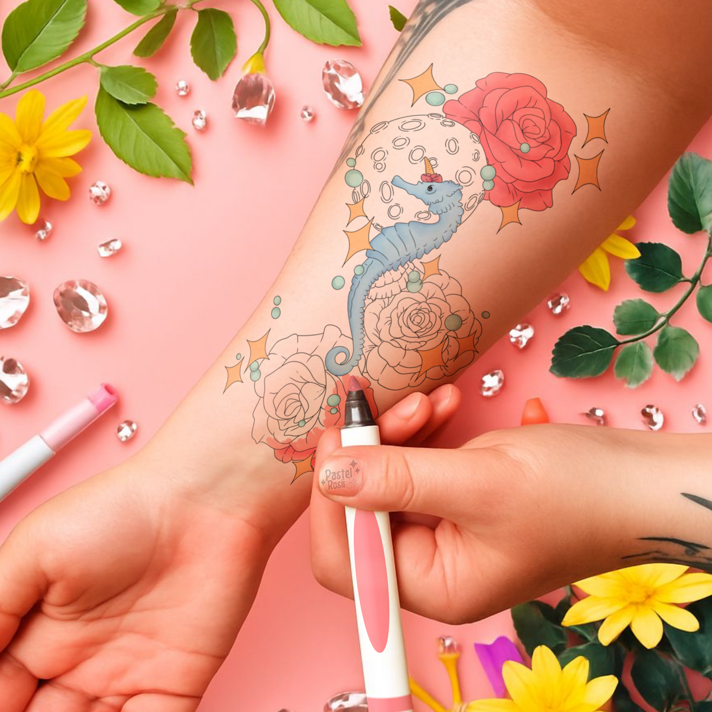 Temporary tattoos of a seahorse and roses on a person's arm with decorative elements like flowers and rhinestones.