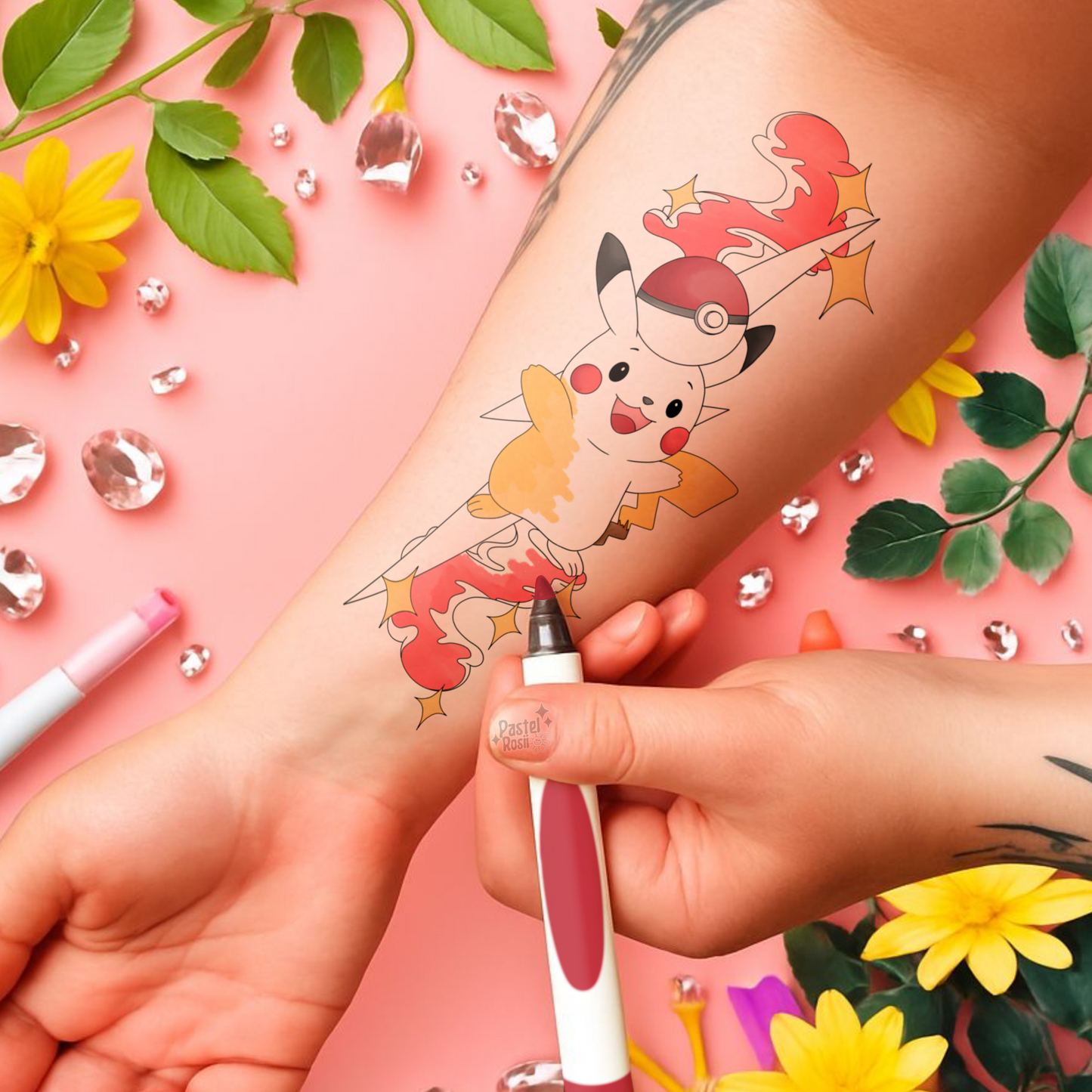 Temporary tattoo of a cartoon character being applied on a person's arm with decorative elements like flowers and leaves in the background.
