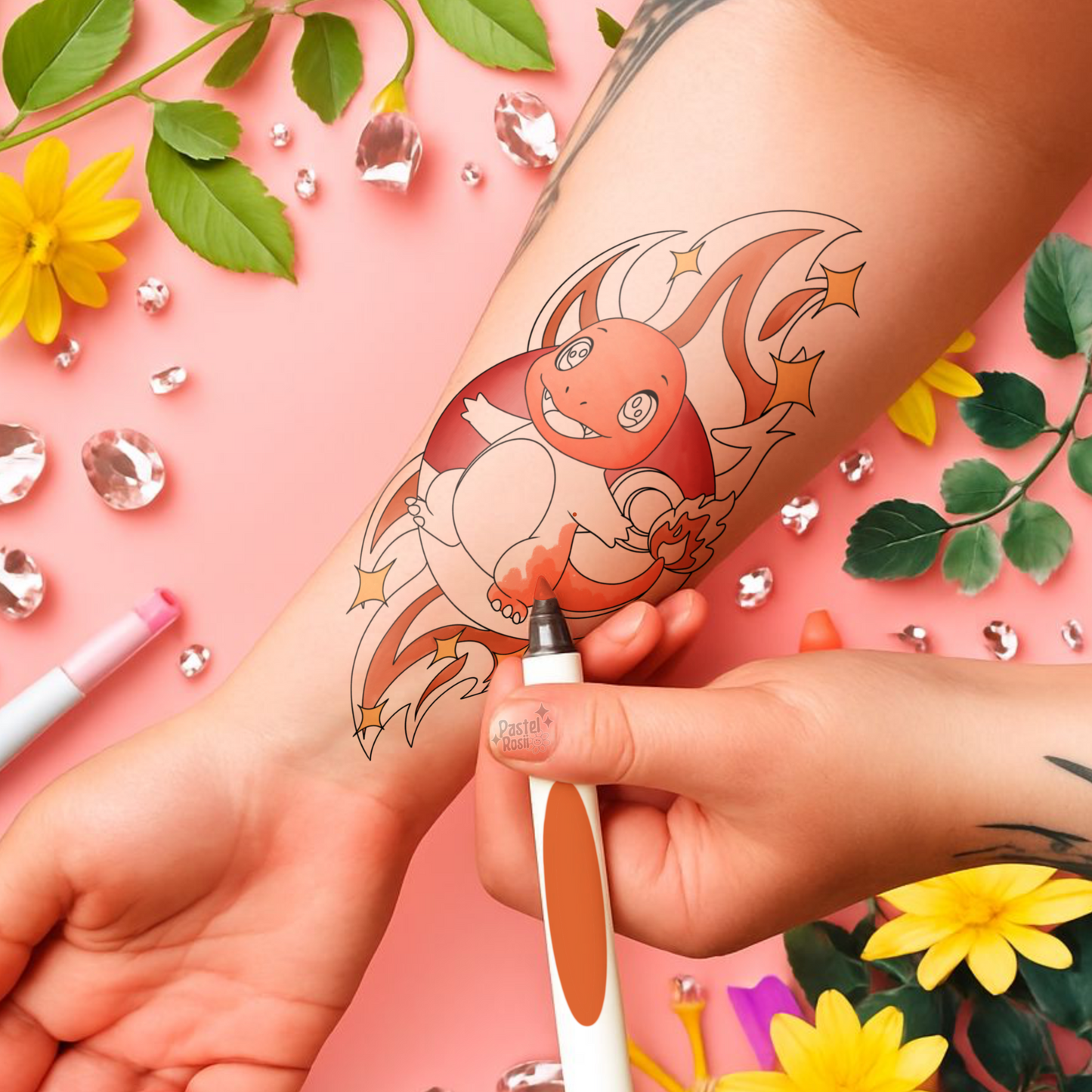 Hand with a temporary tattoo of a cartoon character, surrounded by flowers and decorative elements on a pink background.