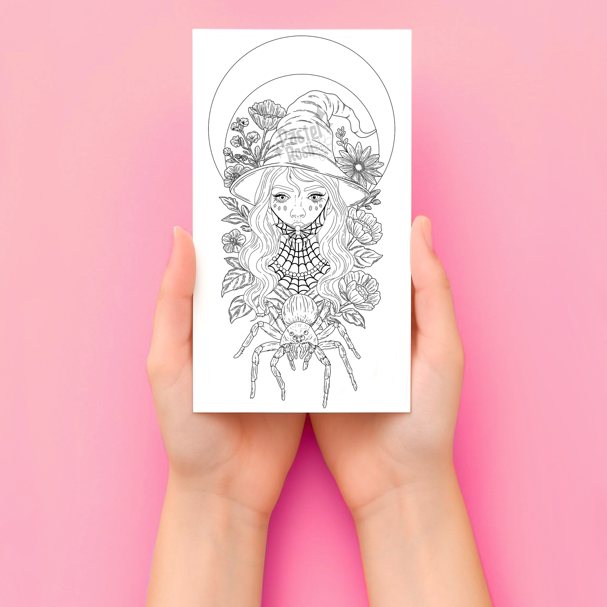 Hands holding a temporary tattoo with a detailed illustration of a woman with flowers and a spider on a pink background.