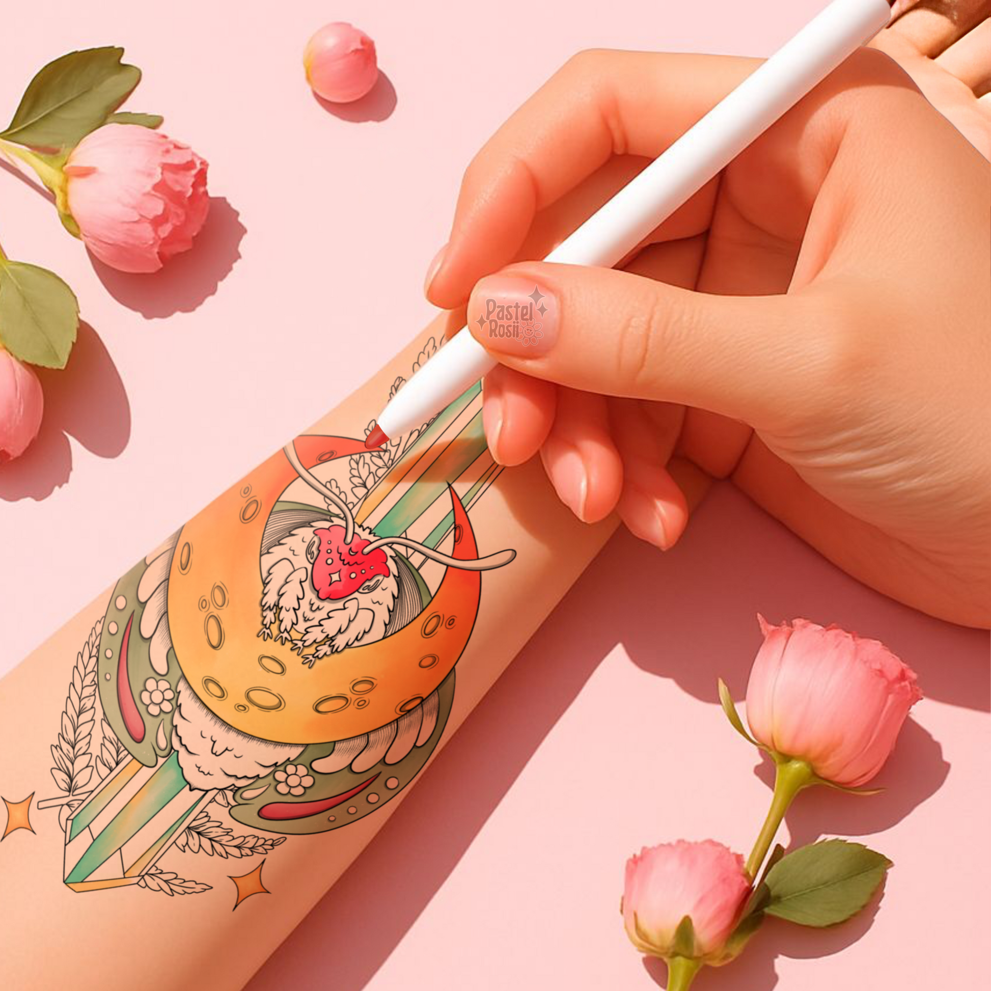 Hand holding a white pen with a tattoo design on a pink background with flowers