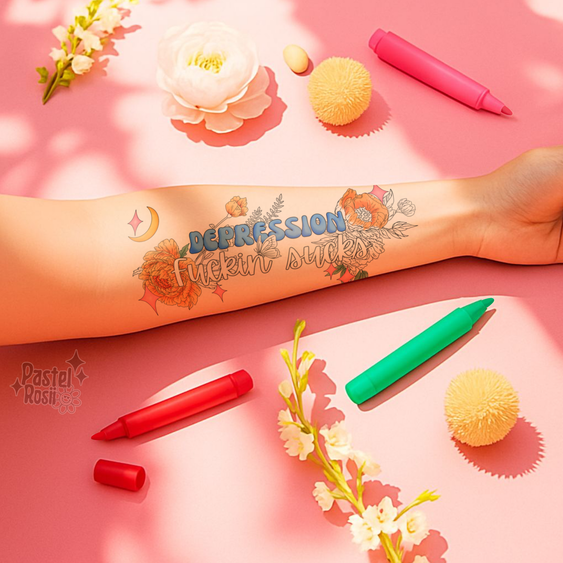 Tattoo of 'Depression Fuckin' Sucks' on a arm with colorful markers and flowers on a pink background.