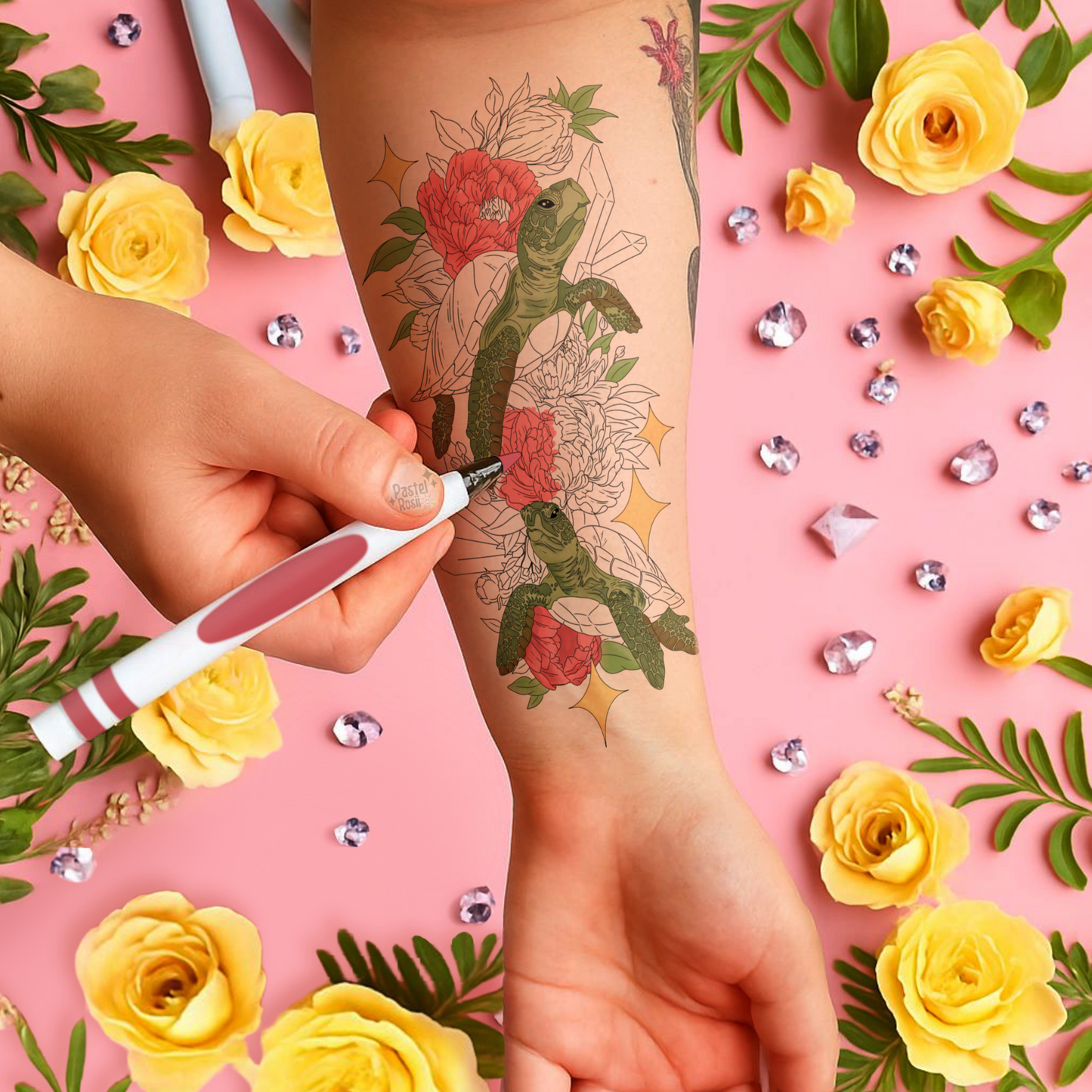 Person getting a tattoo of a turtle and flowers on a pink background with yellow roses and green leaves.